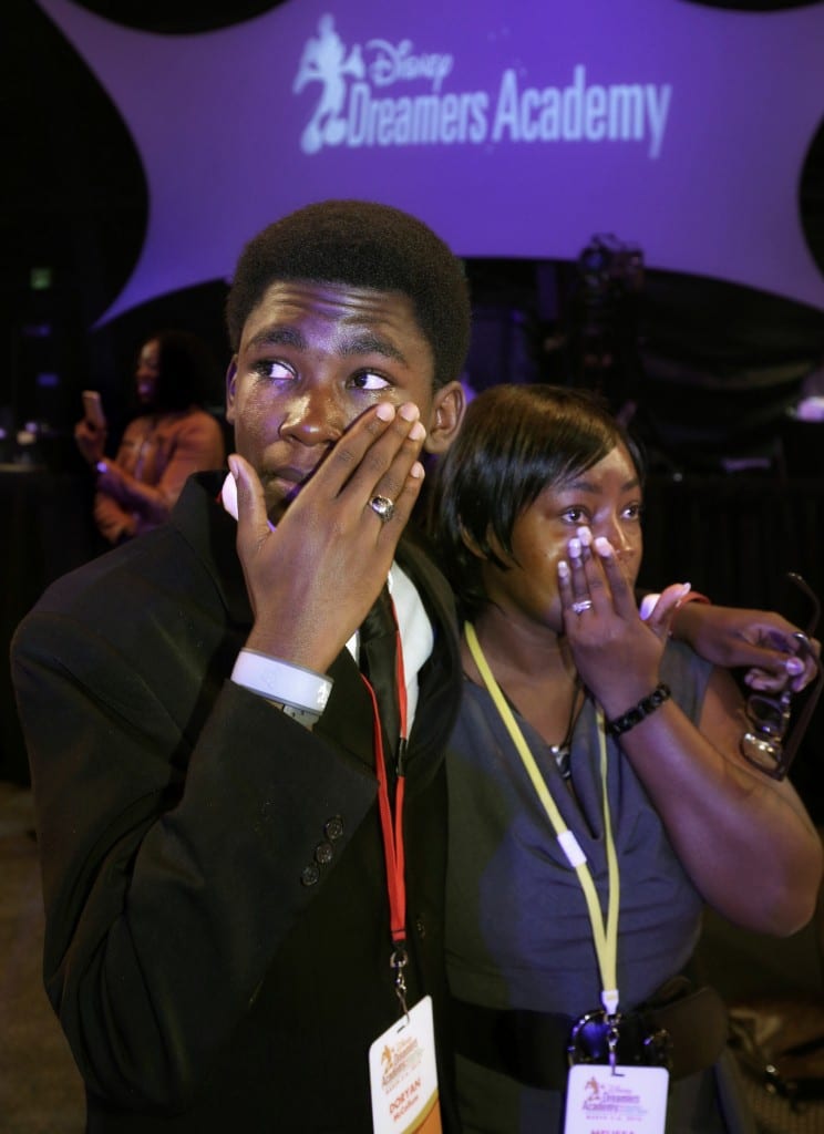 Disney Dreamer Doryan McCallum of Charlotte, NC. weeps alongside Melissa Colvert during the commencement ceremony for the class of 2016 of Disney Dreamers Academy at Epcot in Lake Buena Vista, Fla., March 6, 2016. Epcot is one of four theme parks at Walt Disney World Resort.