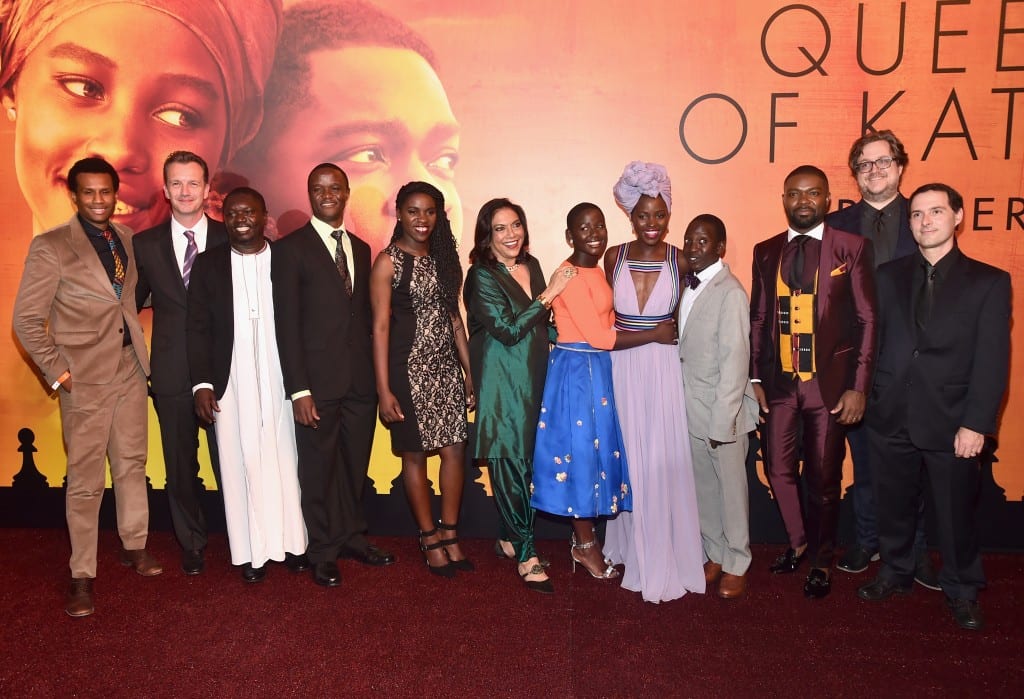 HOLLYWOOD, CA - SEPTEMBER 20: (L-R) Executive Vice President of Production, The Walt Disney Studios, Tendo Nagenda, President of Walt Disney Studios Motion Picture Production, Sean Bailey, chaperone Mark Mugwana, Chess Coach and Director of Sports Outreach in Uganda, Robert Katende, Ugandan national chess champion Phiona Mutesi, Director Mira Nair, actors Madina Nalwanga, Lupita Nyong'o, Martin Kabanza and David Oyelowo, screenwriter William Wheeler and composer Alex Heffes arrive at the U.S. premiere of Disneys Queen of Katwe at the El Capitan Theatre in Hollywood. The film, starring David Oyelowo, Oscar winner Lupita Nyongo and newcomer Madina Nalwanga, is directed by Mira Nair and opens in U.S. theaters in limited release on September 23, expanding wide September 30, 2016. On September 20, 2016 in Hollywood, California. (Photo by Alberto E. Rodriguez/Getty Images for Disney) *** Local Caption *** Tendo Nagenda; Mark Mugwana; Madina Nalwanga; Lupita Nyong'o; David Oyelowo; Sean Bailey; Robert Katende; Phiona Mutesi; Mira Nair; Martin Kabanza; William Wheeler; Alex Heffes