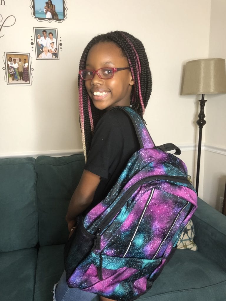 Livy showing off her new backpack from LandsEnd