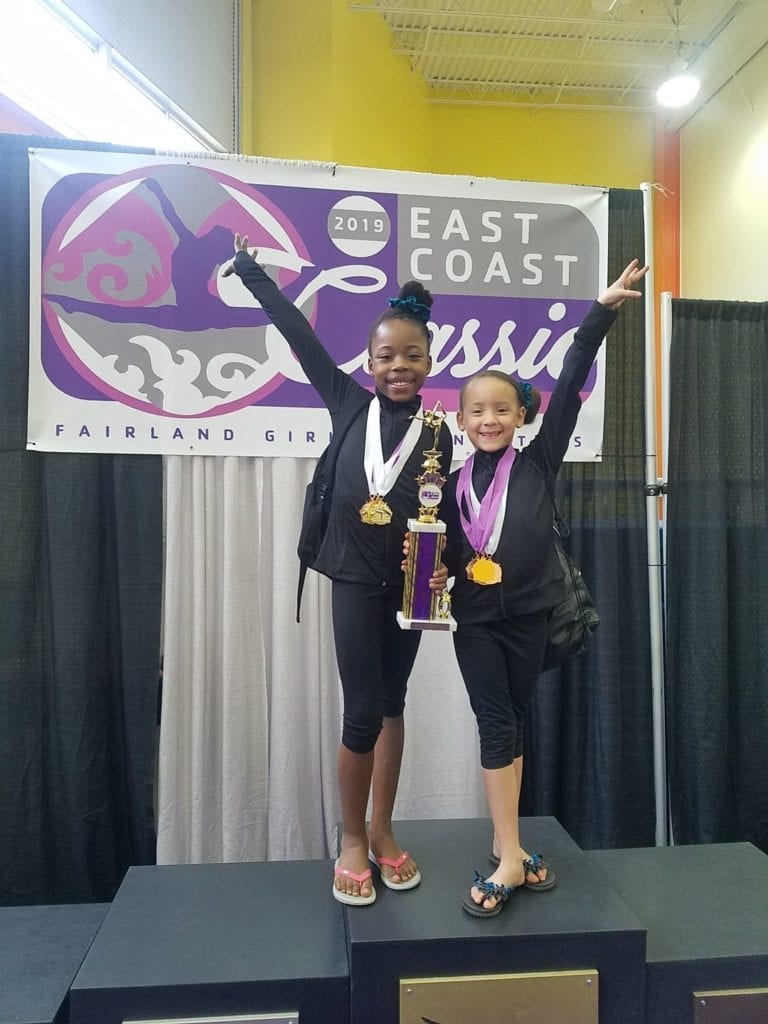 Brielle shares the spotlight with her friend and teamate after their gymnastics meet.